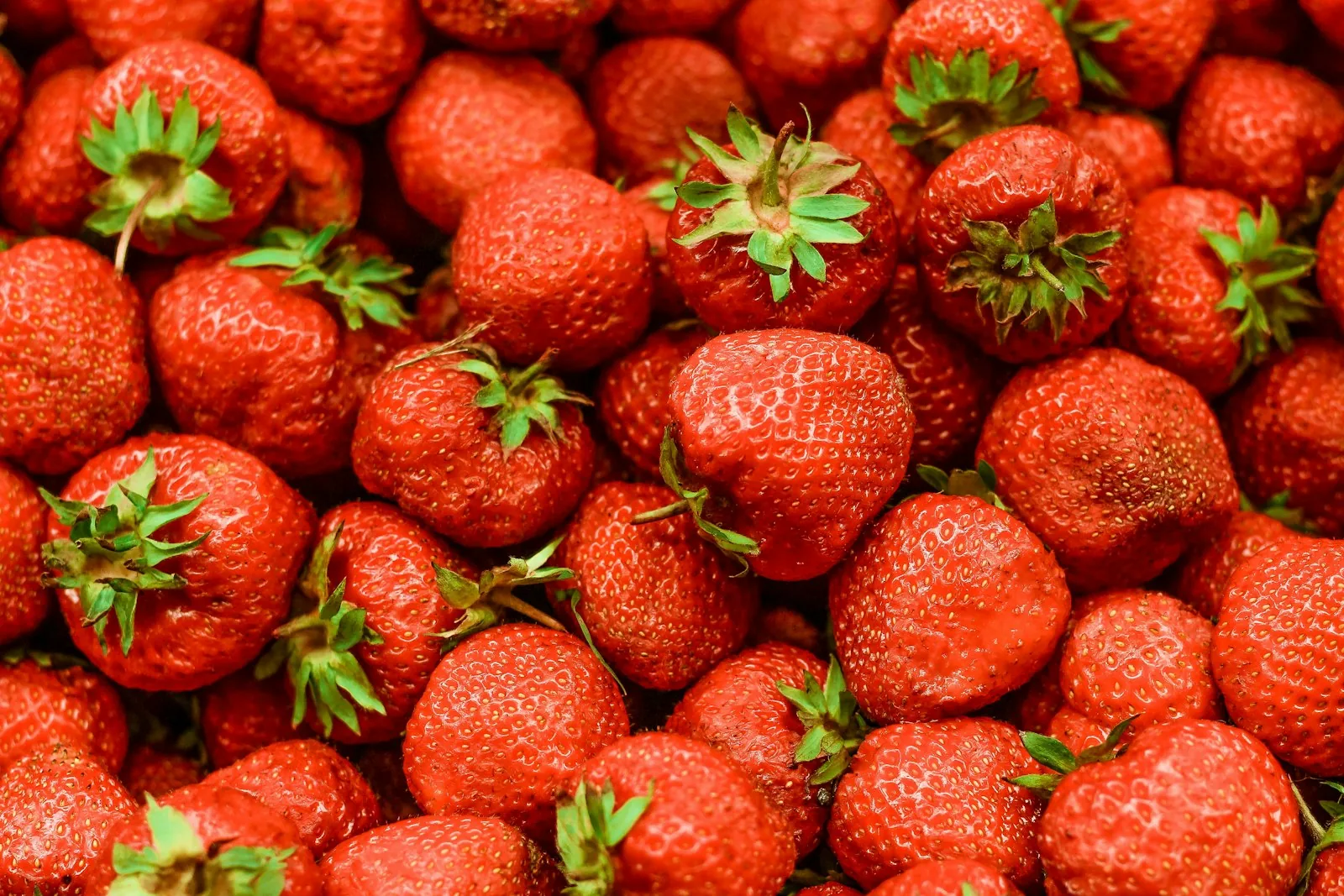 Red strawberries on white surface